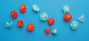 Light blue and red polyhedral dice scattered over a blue background